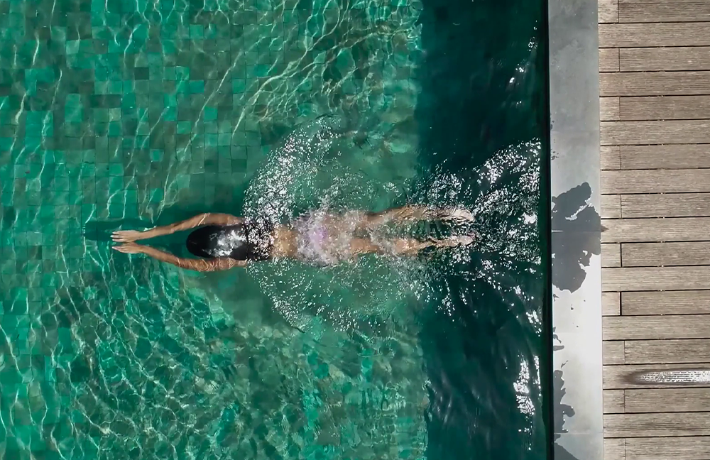 Residents enjoying luxury swimming pool amenities at Riverdale Township, Kharadi Pune — premium leisure lifestyle.